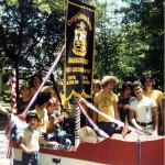 A group of people standing around in a boat.
