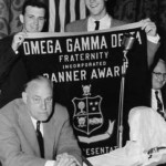 A group of men holding up an award banner.